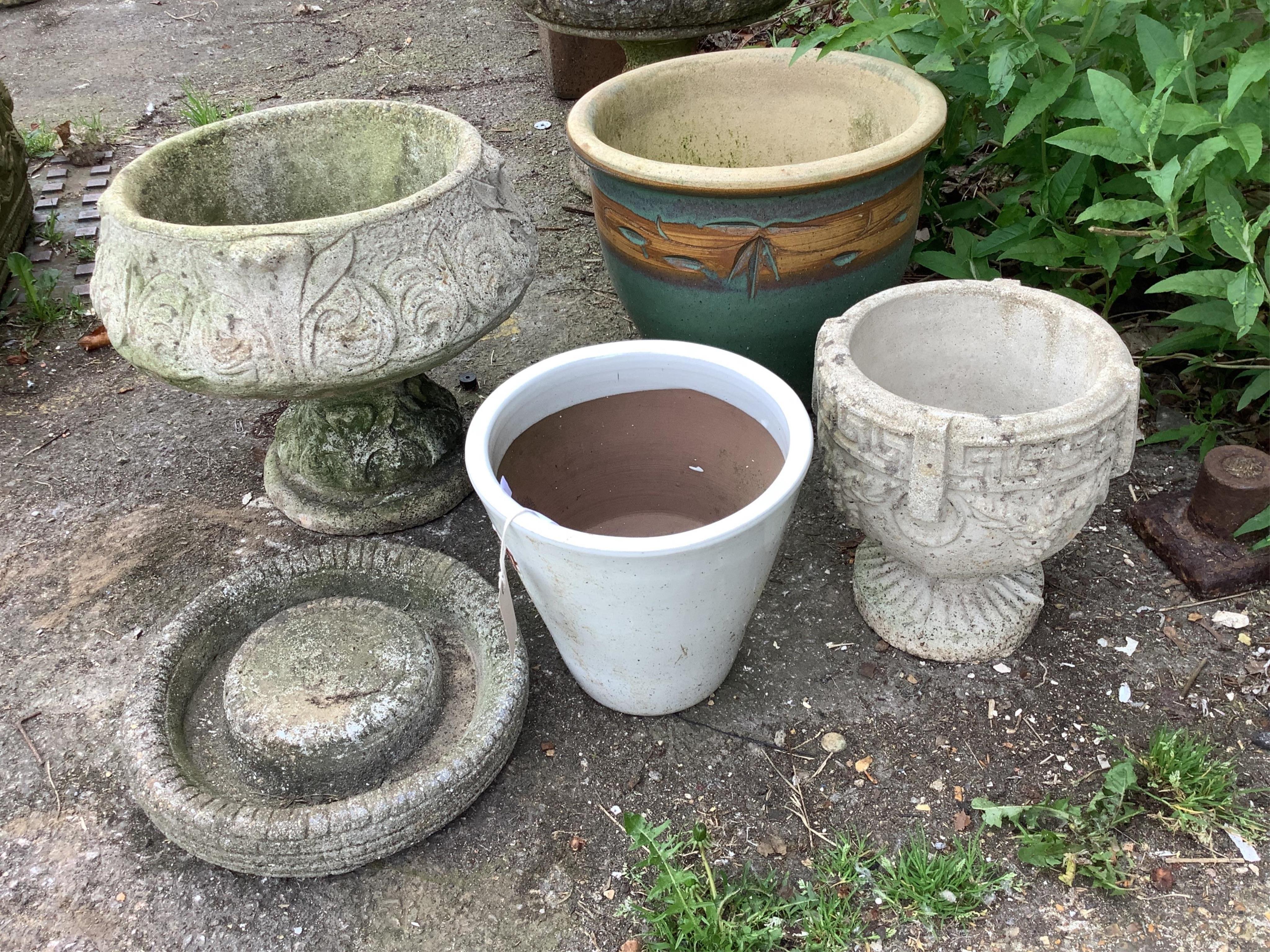 Six assorted stone and earthenware garden planters and a bird bath, largest diameter 38cm, height 32cm